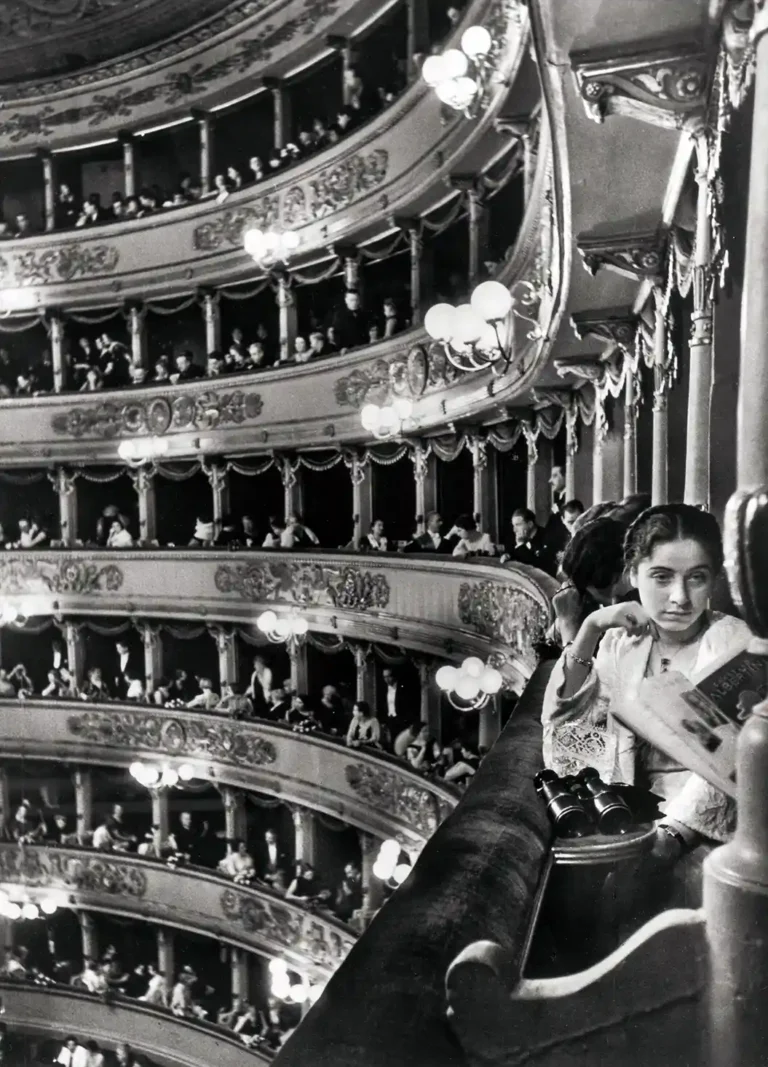 Alfred Eisenstaedt Art Photography Poster featuring a young woman seated in an ornate opera house box seat, captured in black and white.