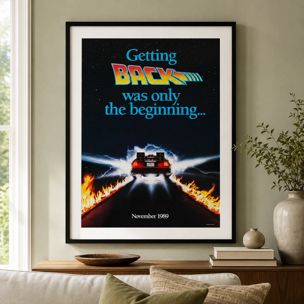 Room mockup of Back to the Future Part II 1989 DeLorean Movie Poster, displayed as framed wall art in a home theater setting as a portrait print with blue and gold tones.