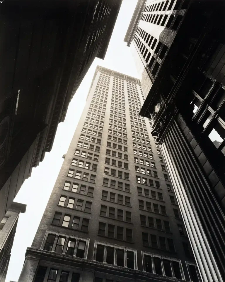 Berenice Abbott architectural photography poster featuring a dramatic upward view of a towering, vintage New York City skyscraper.