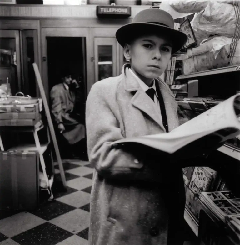 Diane Arbus "Boy in a Fedora" art poster featuring a young boy in a coat and hat staring intensely in a black and white photograph.