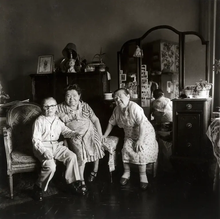 Diane Arbus Fine Art Photography poster featuring three serious people posing in a dimly lit, vintage New York City living room.