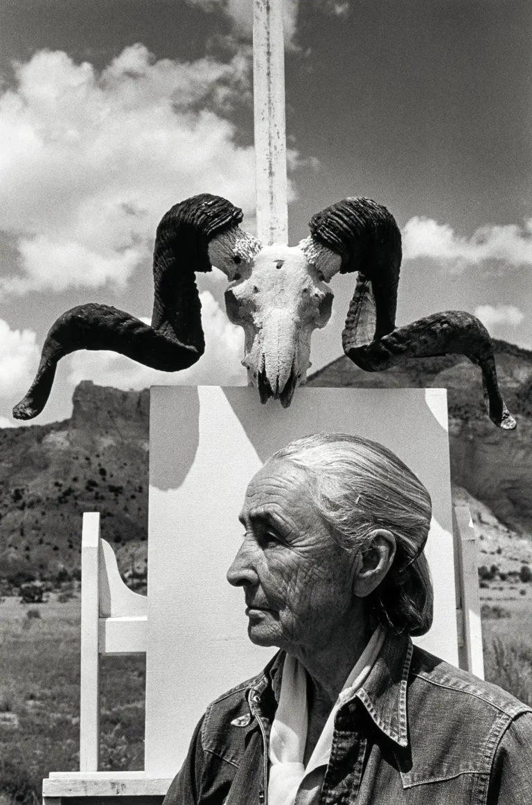 Georgia O'Keeffe Art poster, photographed by Arnold Newman, featuring the artist in profile below a large ram skull in the New Mexico desert landscape.