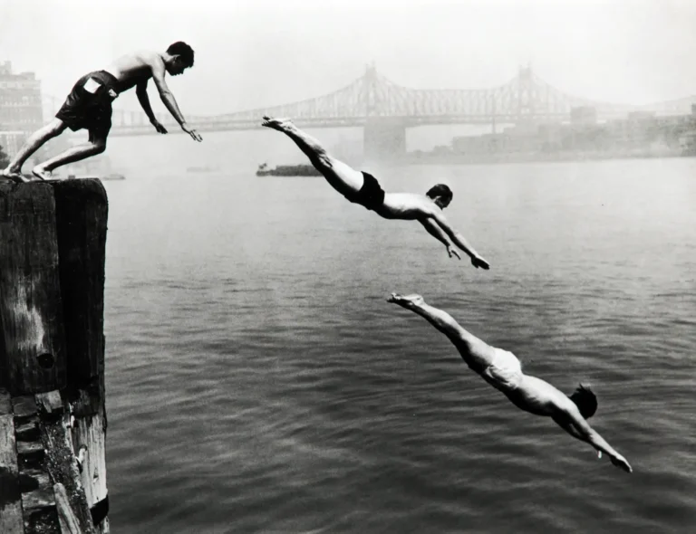 Arthur Leipzig Photography poster featuring three young men diving simultaneously off a wooden pier into the East River, New York City, black and white.