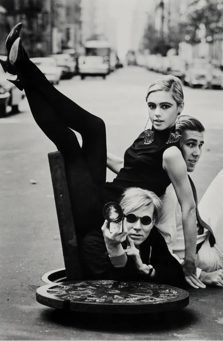 Iconic Andy Warhol and Edie Sedgwick Art Poster by Burt Glinn, featuring the Factory group posing dynamically on a NYC street.