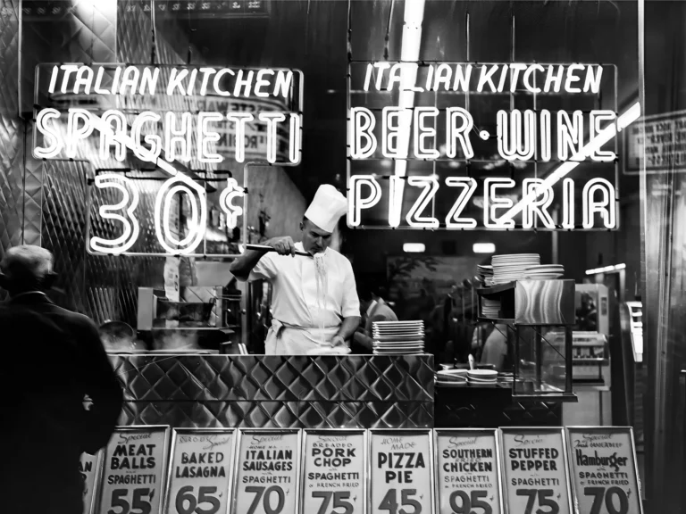 Vintage Italian Kitchen Chef Art poster featuring a black and white scene of a chef cooking spaghetti under neon signs.