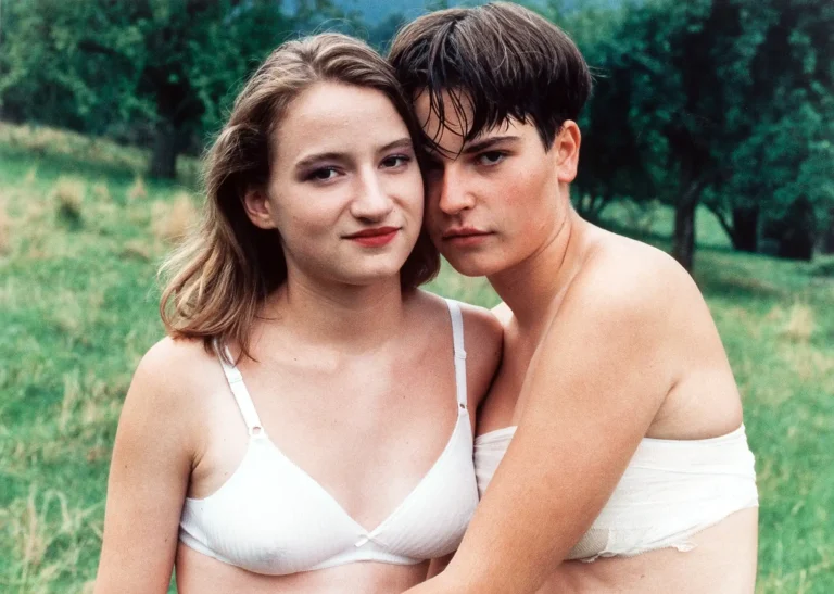 Collier Schorr Fine Art photography poster featuring an intimate color portrait of two embracing teenagers, A.N. and G.S., set against a green, wooded background.