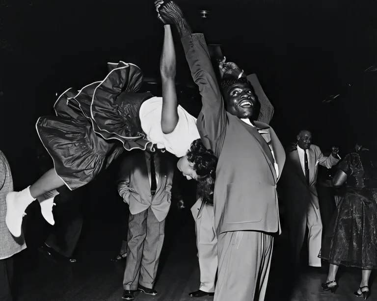 Savoy Ballroom Dancers vintage photo poster of an African American couple mid-air in a dynamic Lindy Hop swing dance, black and white.