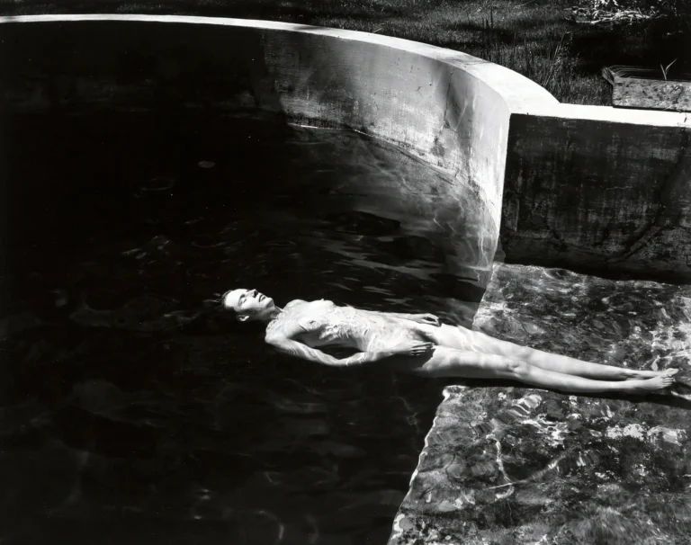 Edward Weston Fine Art Photography poster featuring a nude figure floating horizontally in a dark, concrete pool with high contrast.