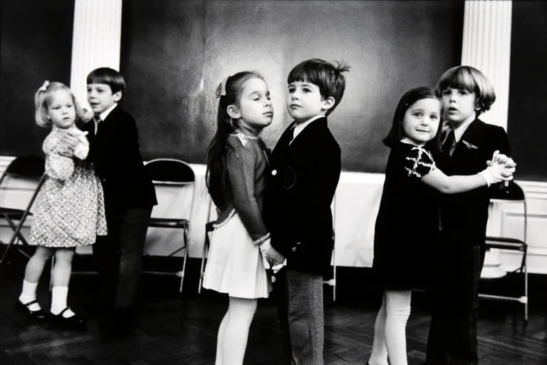 Elliott Erwitt classic black and white photography poster featuring several pairs of formally dressed children dancing in a ballroom.