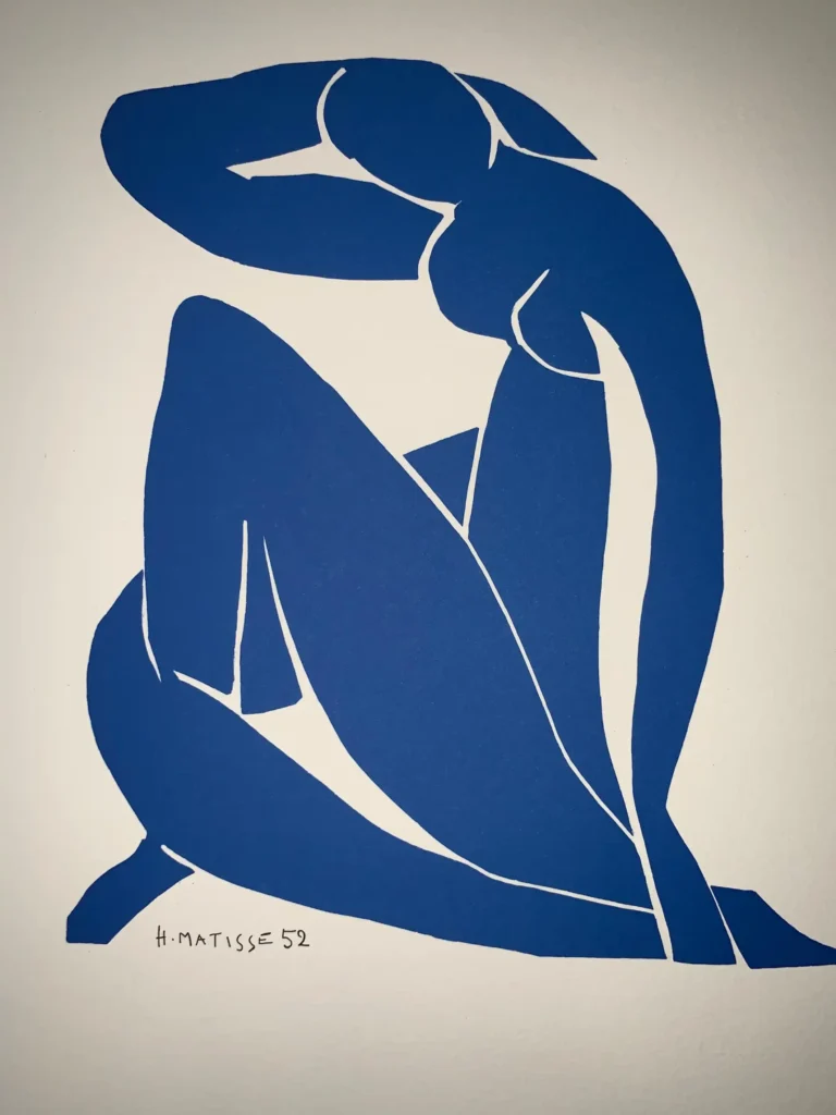 Henri Matisse 'Blue Nude II' art poster featuring a minimalist, abstract seated female figure in bold blue against a white background.