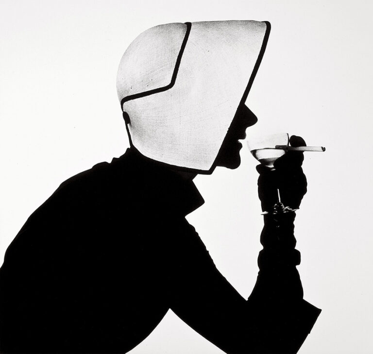 Irving Penn fine art photography poster featuring the dramatic black and white silhouette of a woman wearing a geometric bonnet and drinking.