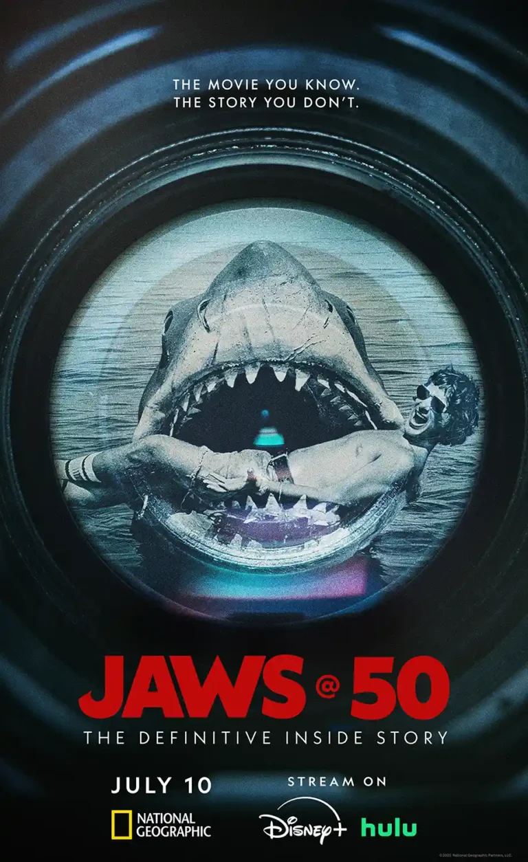 Jaws movie poster featuring the Great White Shark with a victim struggling inside its massive jaws, viewed through a circular camera lens.