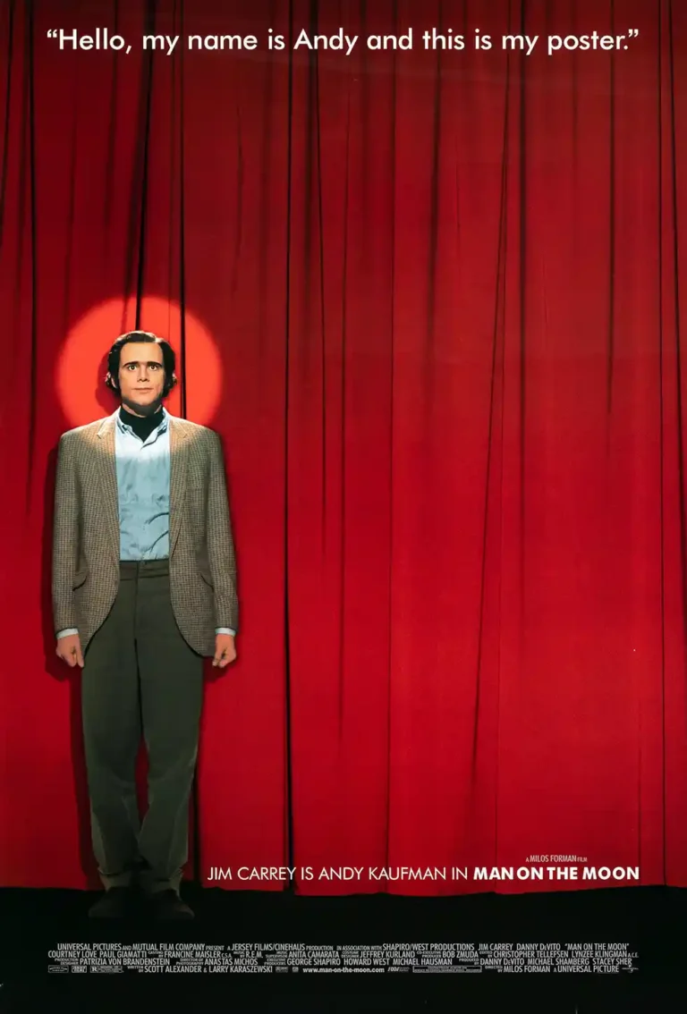 Man on the Moon Movie poster featuring Jim Carrey as Andy Kaufman standing center stage against a vibrant red velvet curtain with a single spotlight.
