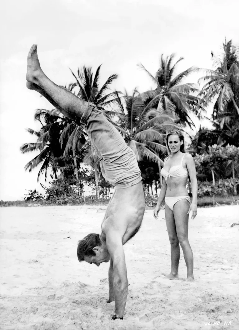Sean Connery James Bond movie poster featuring him doing a handstand on a beach with Ursula Andress from Dr. No.