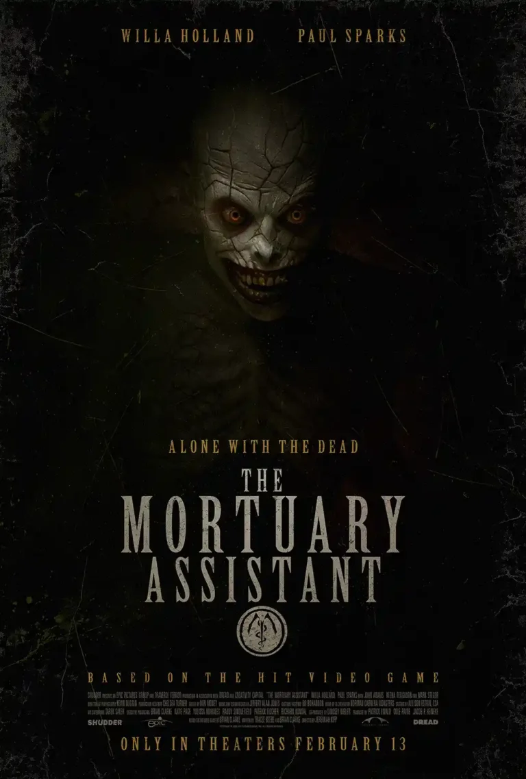 The Mortuary Assistant horror movie poster featuring the grinning, pale demon with cracked skin, yellowed teeth, and glowing orange eyes emerging from the dark.