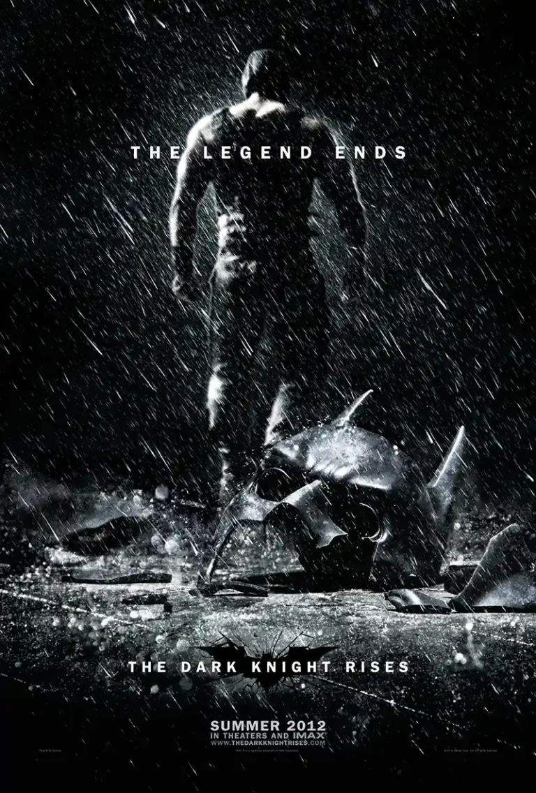 The Dark Knight Rises Movie poster featuring the villain Bane standing in the rain over Batman's broken cowl. Gritty black and white aesthetic.
