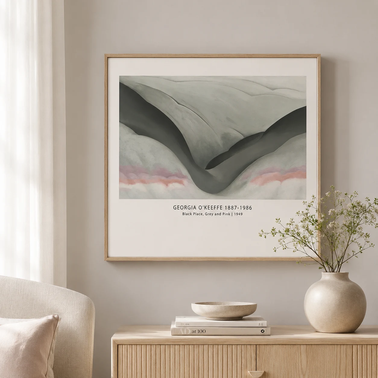 Room mockup of Black Place Print, Georgia O'Keeffe Grey Pink Desert Art, displayed as framed wall art in a living room setting as a landscape print with pink, grey, and black tones.