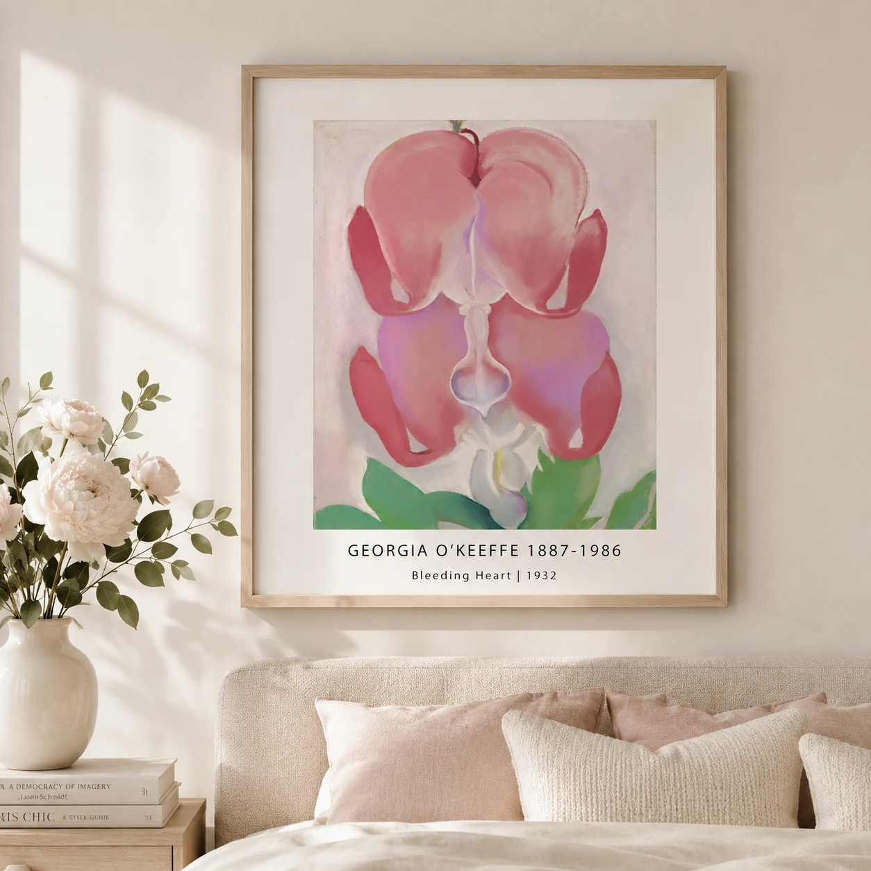 Room mockup of Bleeding Heart Print, Georgia O'Keeffe Pink Floral Wall Art Print, displayed as framed wall art in a bedroom setting as a portrait print with green and pink tones.