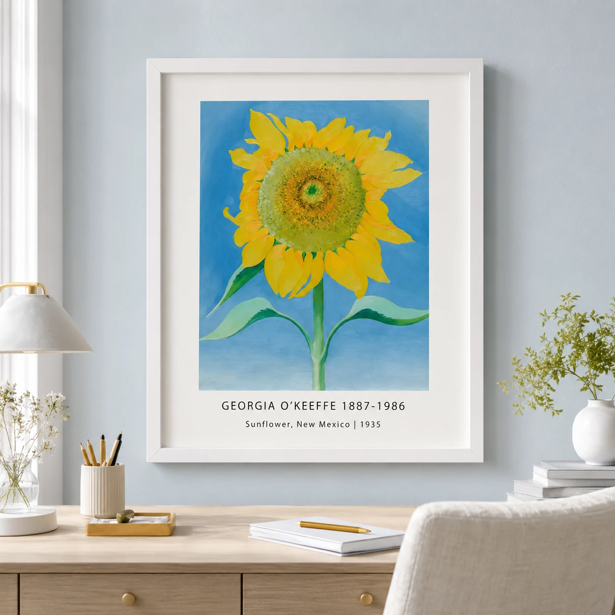 Room mockup of Sunflower New Mexico Print, O'Keeffe Bright Floral Wall Art Print, displayed as framed wall art in a bedroom setting as a portrait print with blue, green, and yellow tones.