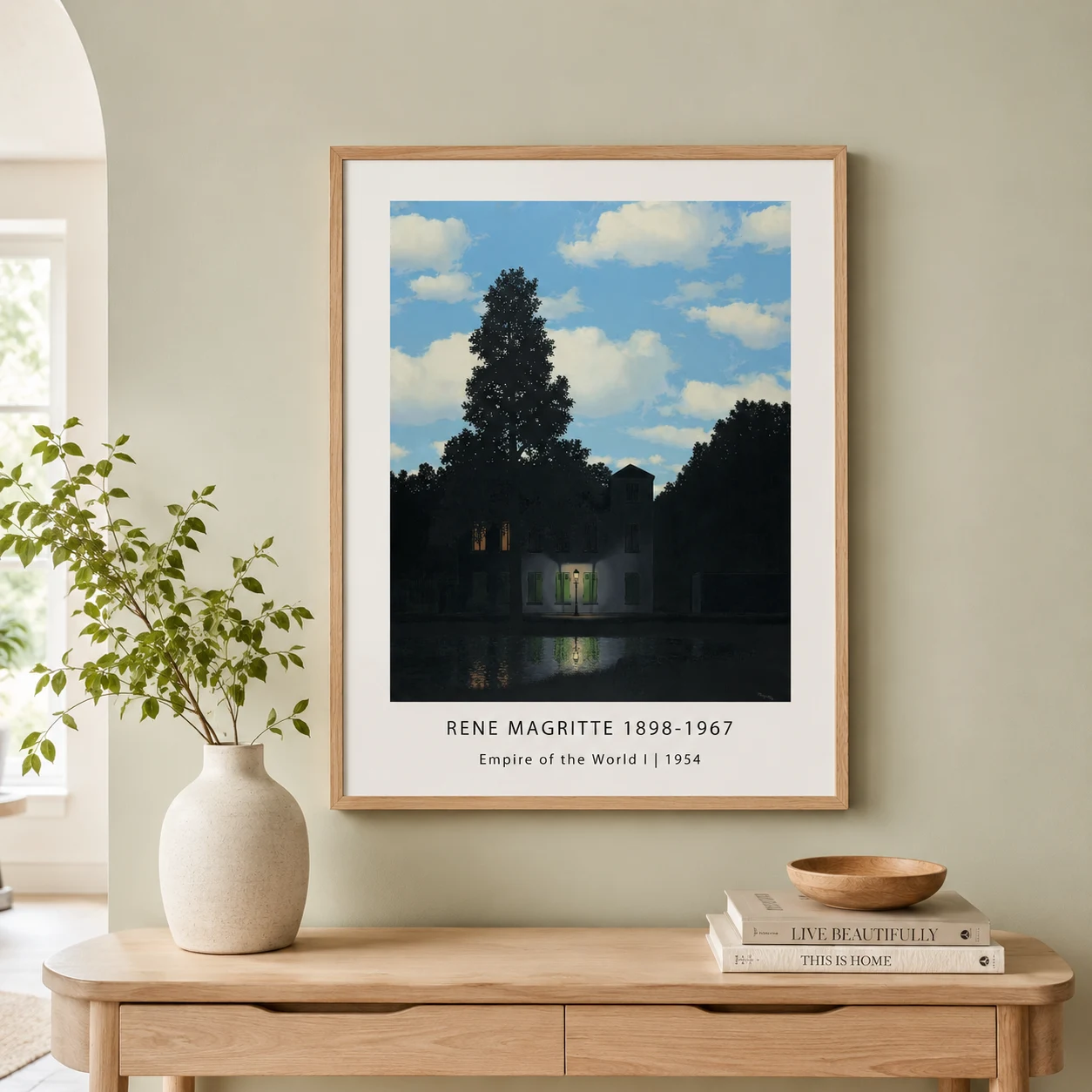 Room mockup of Empire World Poster, Magritte Day-Night House Wall Art Print, displayed as framed wall art in a living room setting as a portrait print with blue and white tones.