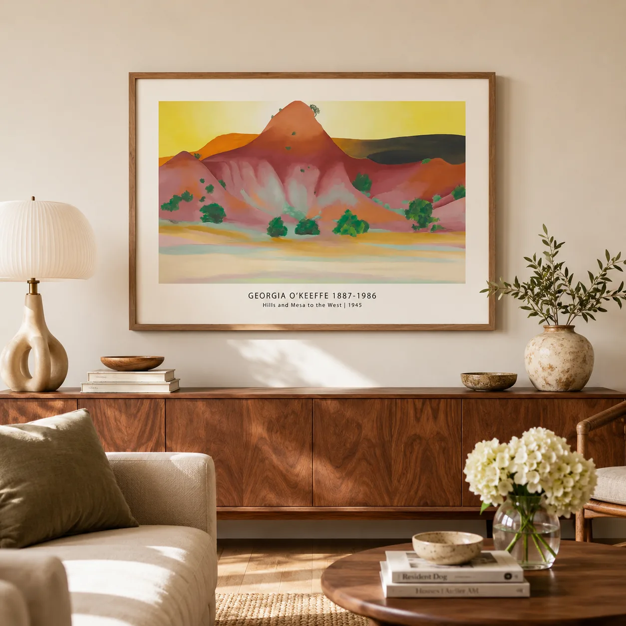 Room mockup of Hills and Mesa Print, Georgia O'Keeffe Desert Wall Art Print, displayed as framed wall art in a living room setting as a landscape print with green, yellow, and red tones.