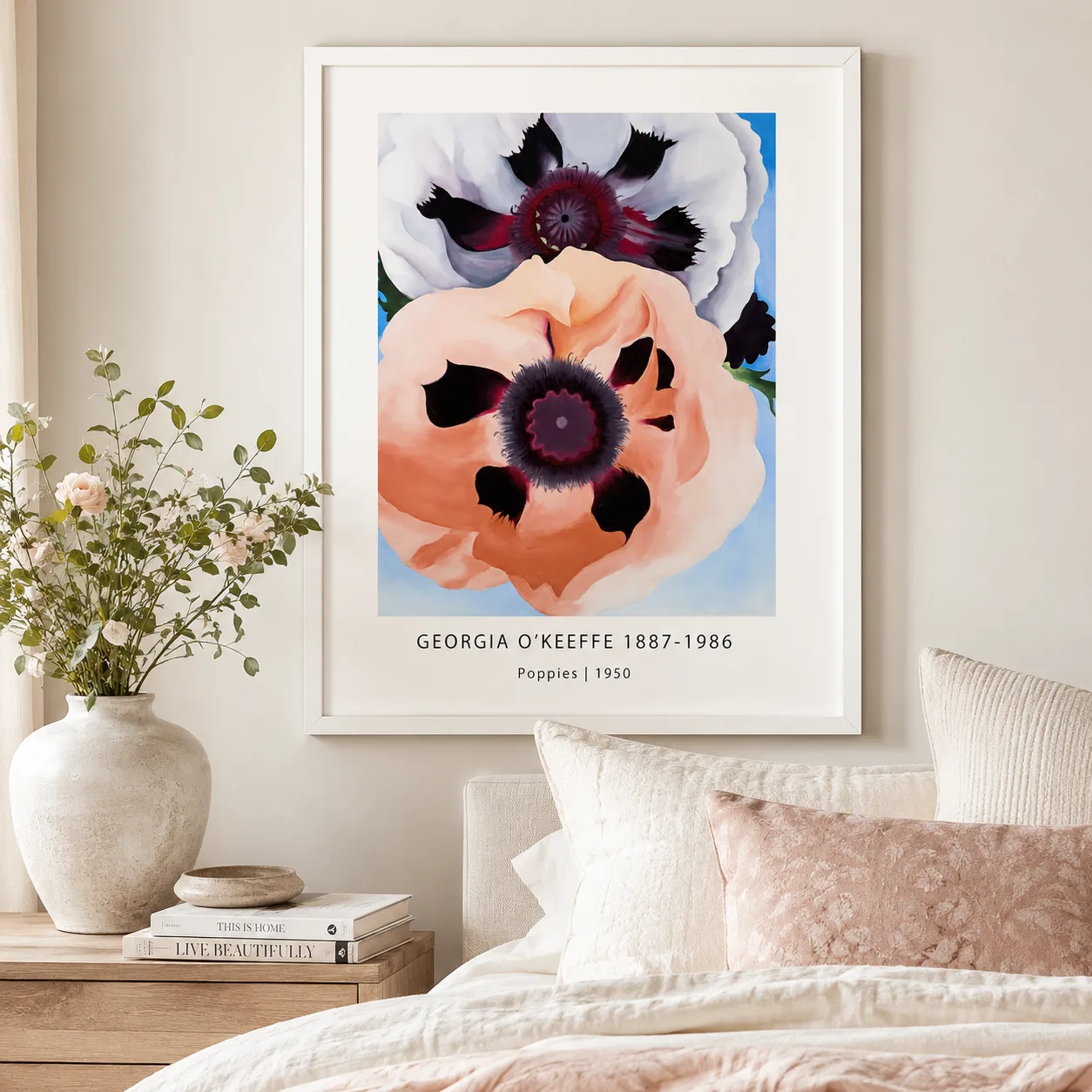 Room mockup of Poppies Print, Georgia O'Keeffe Modern Floral Wall Art Print, displayed as framed wall art in a bedroom setting as a portrait print with orange and red tones.