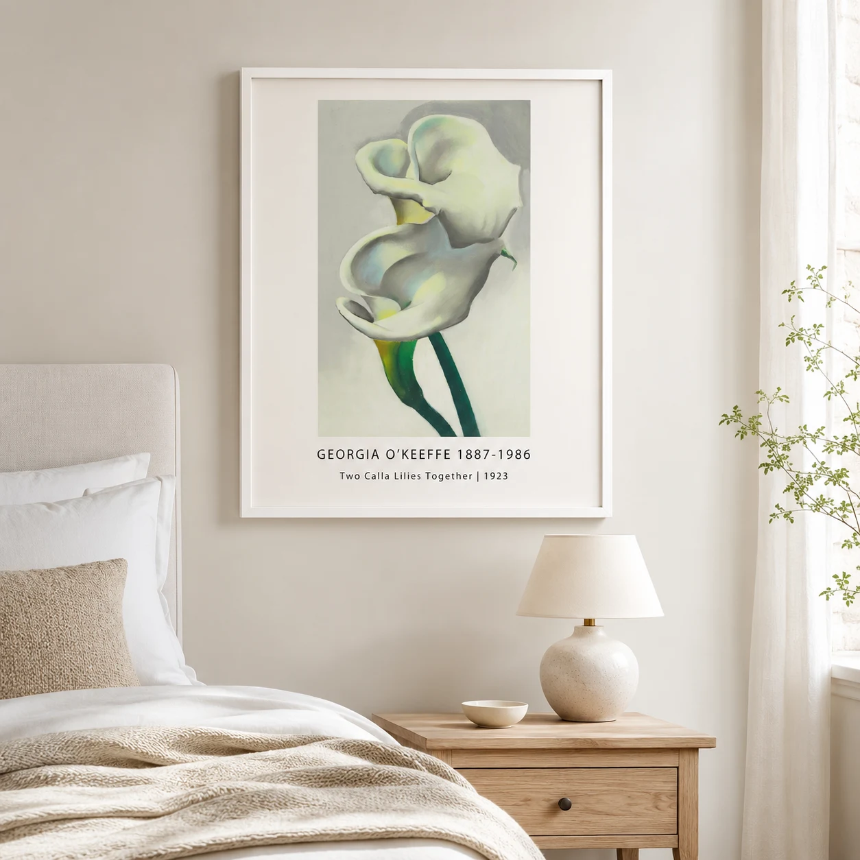 Room mockup of Calla Lilies Print, Georgia O'Keeffe White Floral Art, displayed as framed wall art in a bedroom setting as a portrait print with green and white tones.