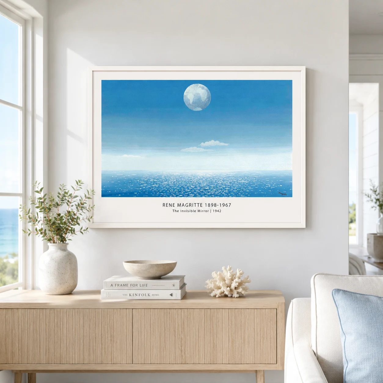 Room mockup of Invisible Mirror Print, Magritte Moon Over Sea Wall Art Print, displayed as framed wall art in a bedroom setting as a landscape print with blue tones.