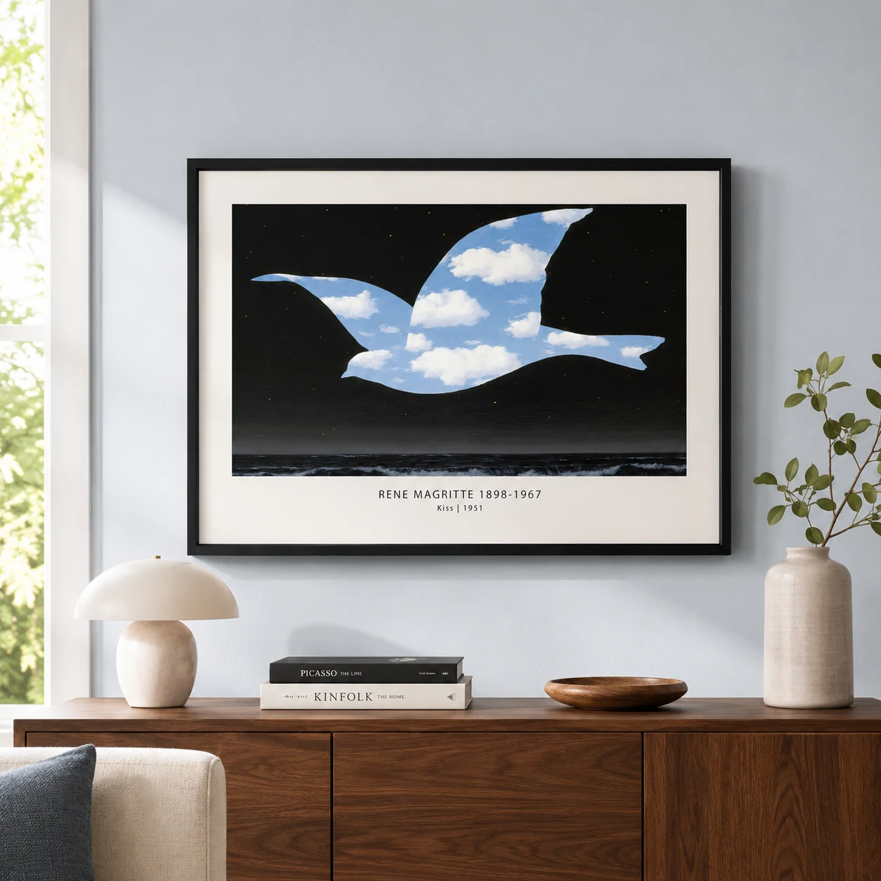 Room mockup of Magritte Bird Print, The Kiss Cloud Ocean Wall Art Print, displayed as framed wall art in a bedroom setting as a landscape print with blue tones.