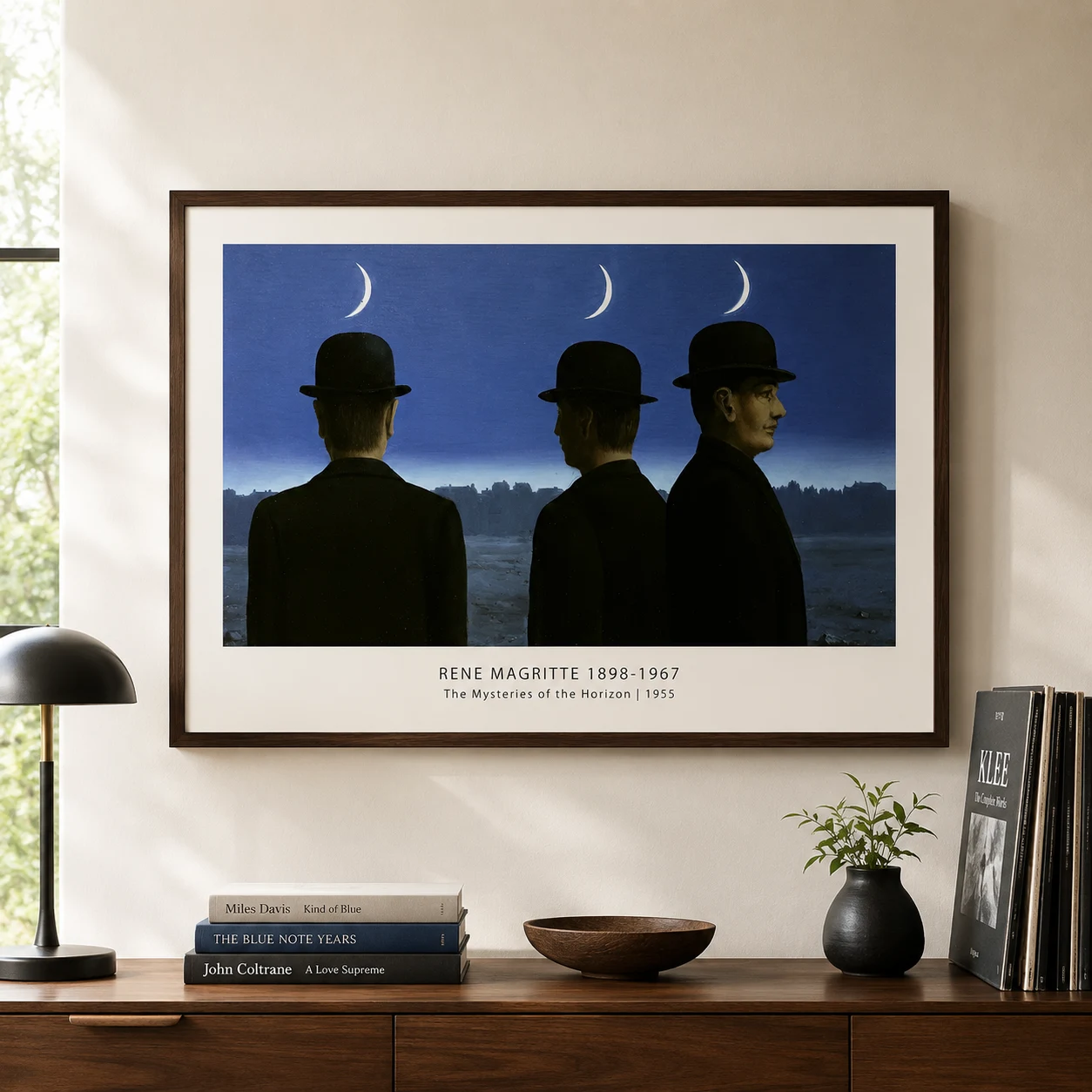 Room mockup of Magritte Horizon Print, Three Bowler Hat Men Wall Art Print, displayed as framed wall art in a living room setting as a landscape print with blue tones.