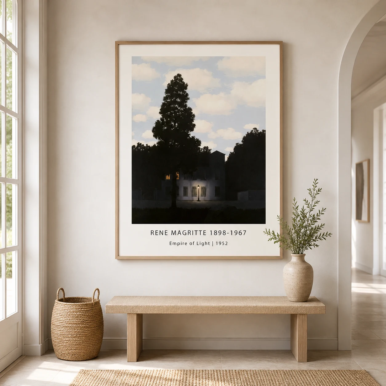 Room mockup of Magritte House Print, Empire of Light Surreal Wall Art Print, displayed as framed wall art in a living room setting as a portrait print with blue and white tones.