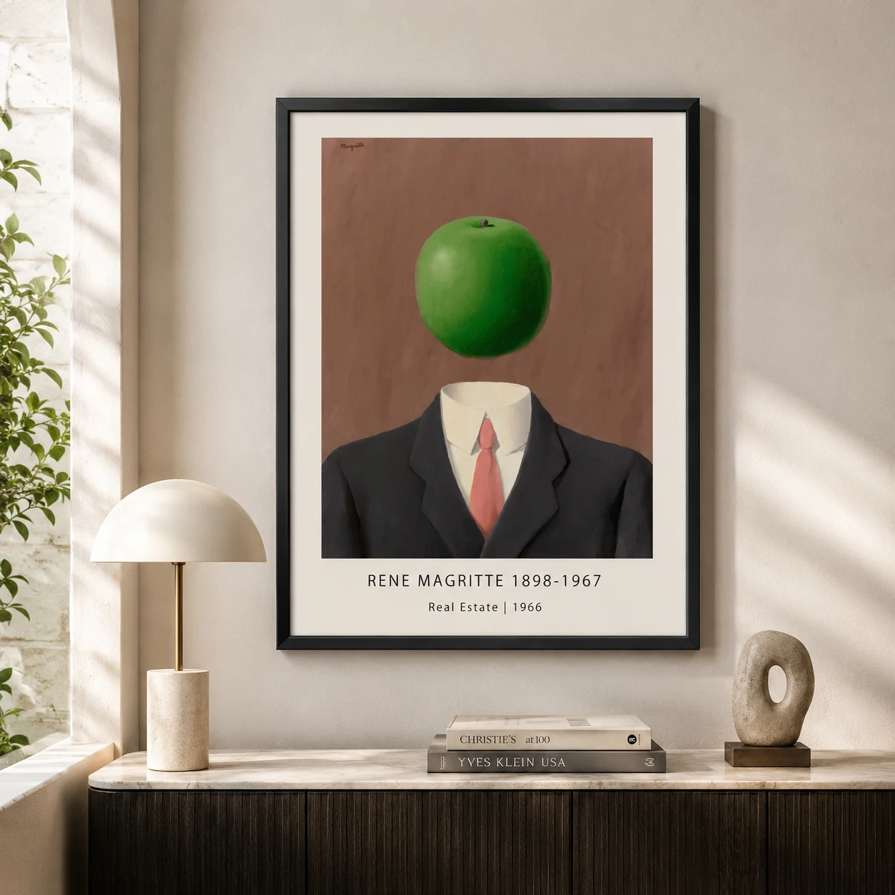 Room mockup of Magritte Real Estate Print, Apple Suit Surrealist Wall Art Print, displayed as framed wall art in a living room setting as a portrait print with green and red tones.