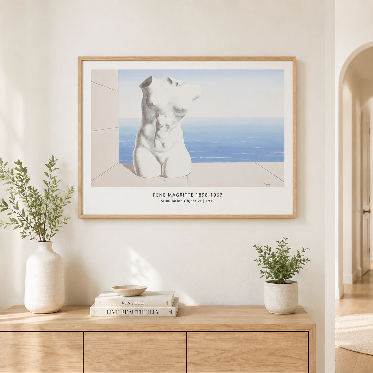 Room mockup of Magritte torso Print, Stimulation Objective Wall Art Print, displayed as framed wall art in a living room setting as a landscape print with blue and white tones.