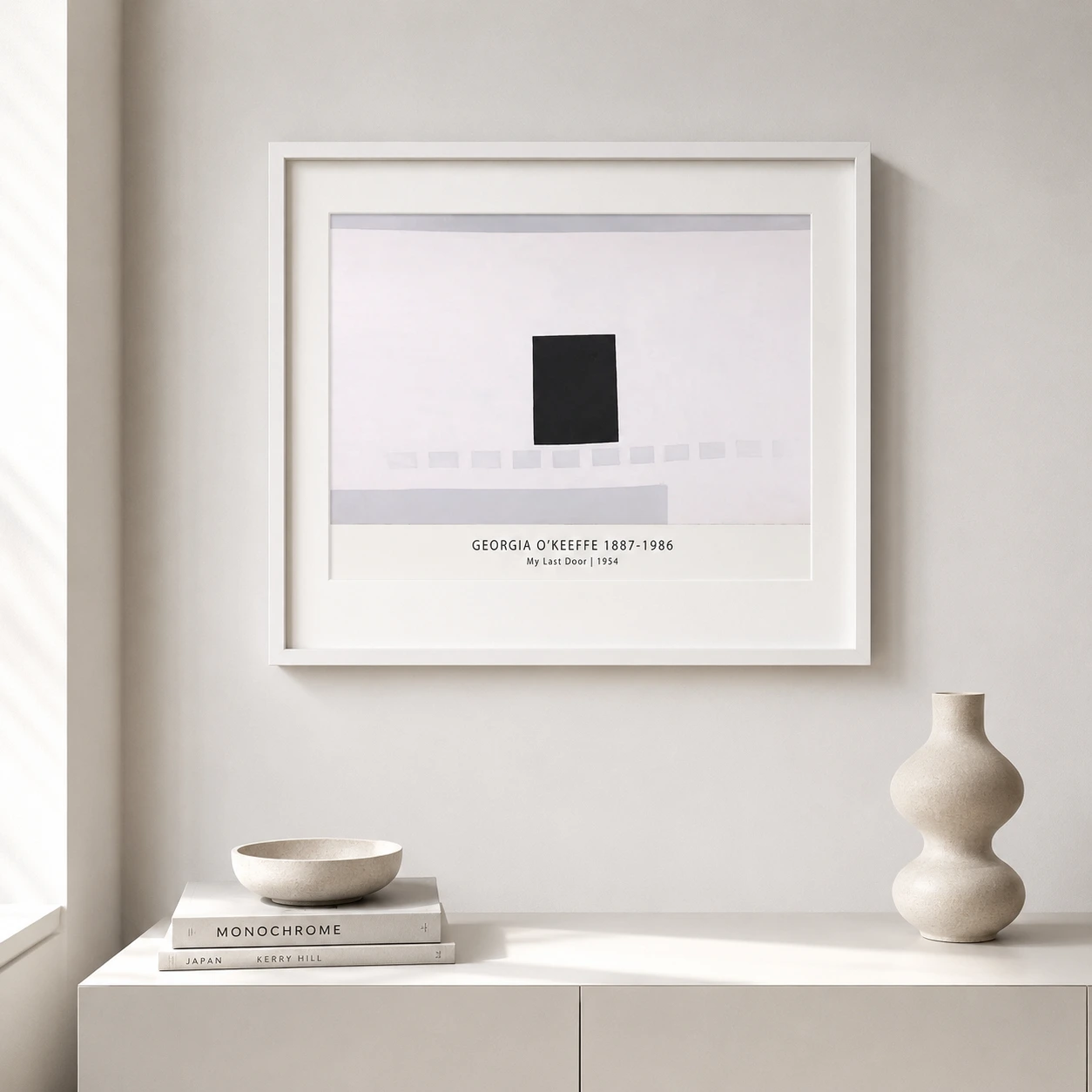 Room mockup of My Last Door Print, Georgia O'Keeffe Black Door Wall Art Print, displayed as framed wall art in a living room setting as a landscape print with black and white and blue tones.