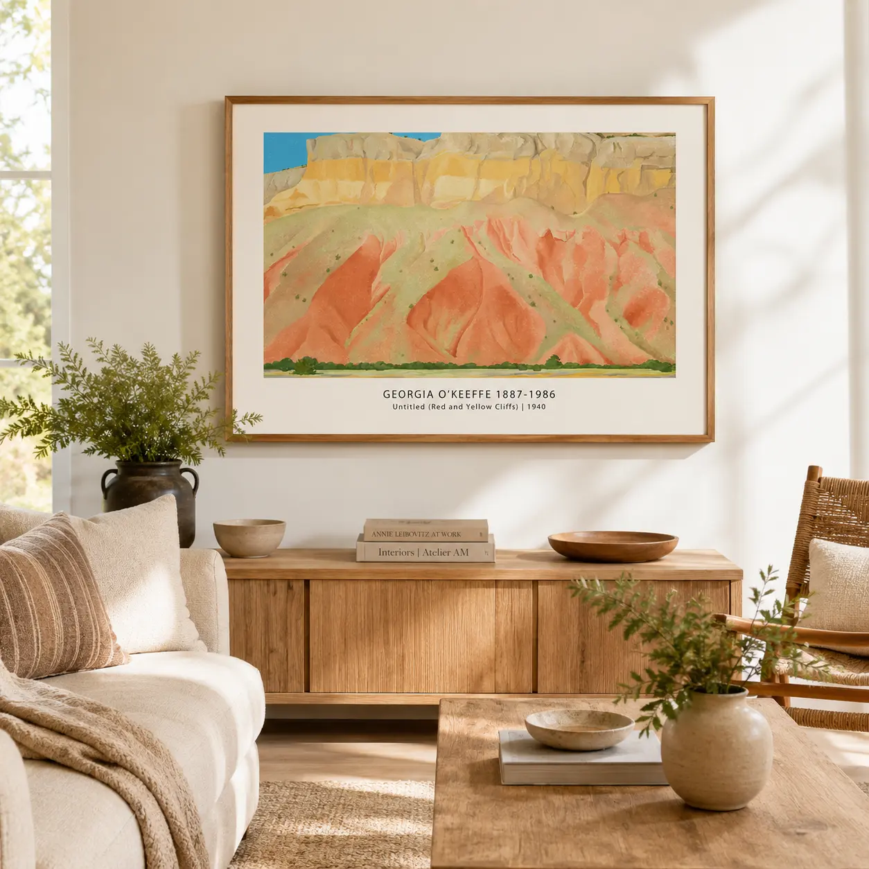 Room mockup of Georgia O'Keeffe Landscape Print, Red and Yellow Cliffs, displayed as framed wall art in a living room setting as a landscape print with blue, yellow, and red tones.