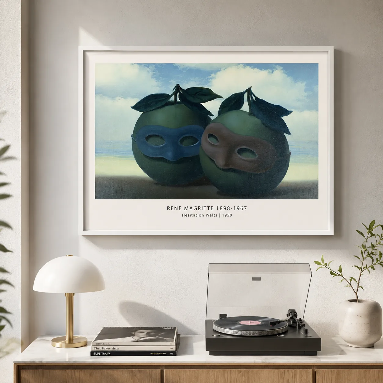 Room mockup of René Magritte Hesitation Waltz Print, Masked Apples Art, displayed as framed wall art in a living room setting as a landscape print with green tones.