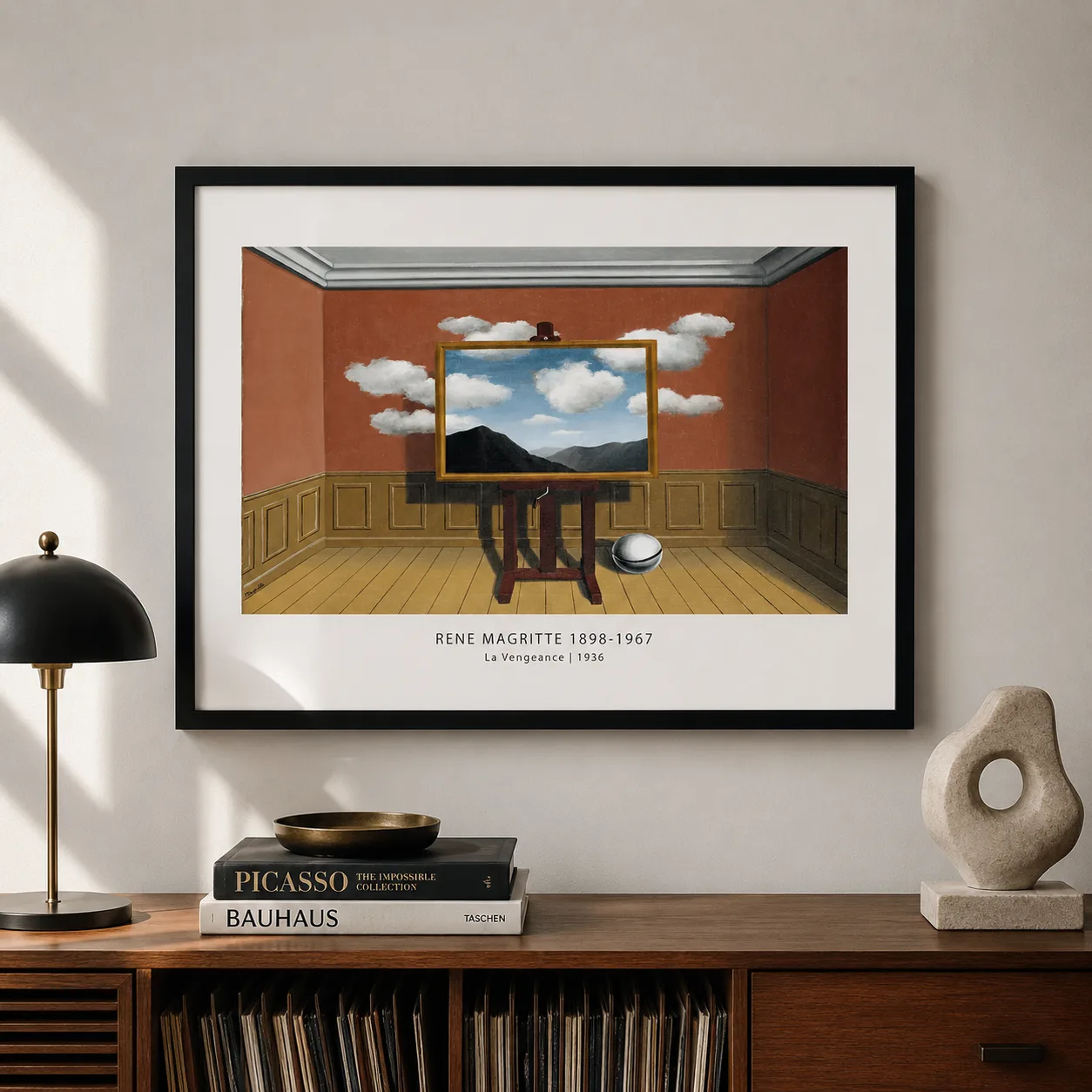 Room mockup of La Vengeance Print, Magritte Easel and Mountain Wall Art Print, displayed as framed wall art in a living room setting as a landscape print with blue and red tones.