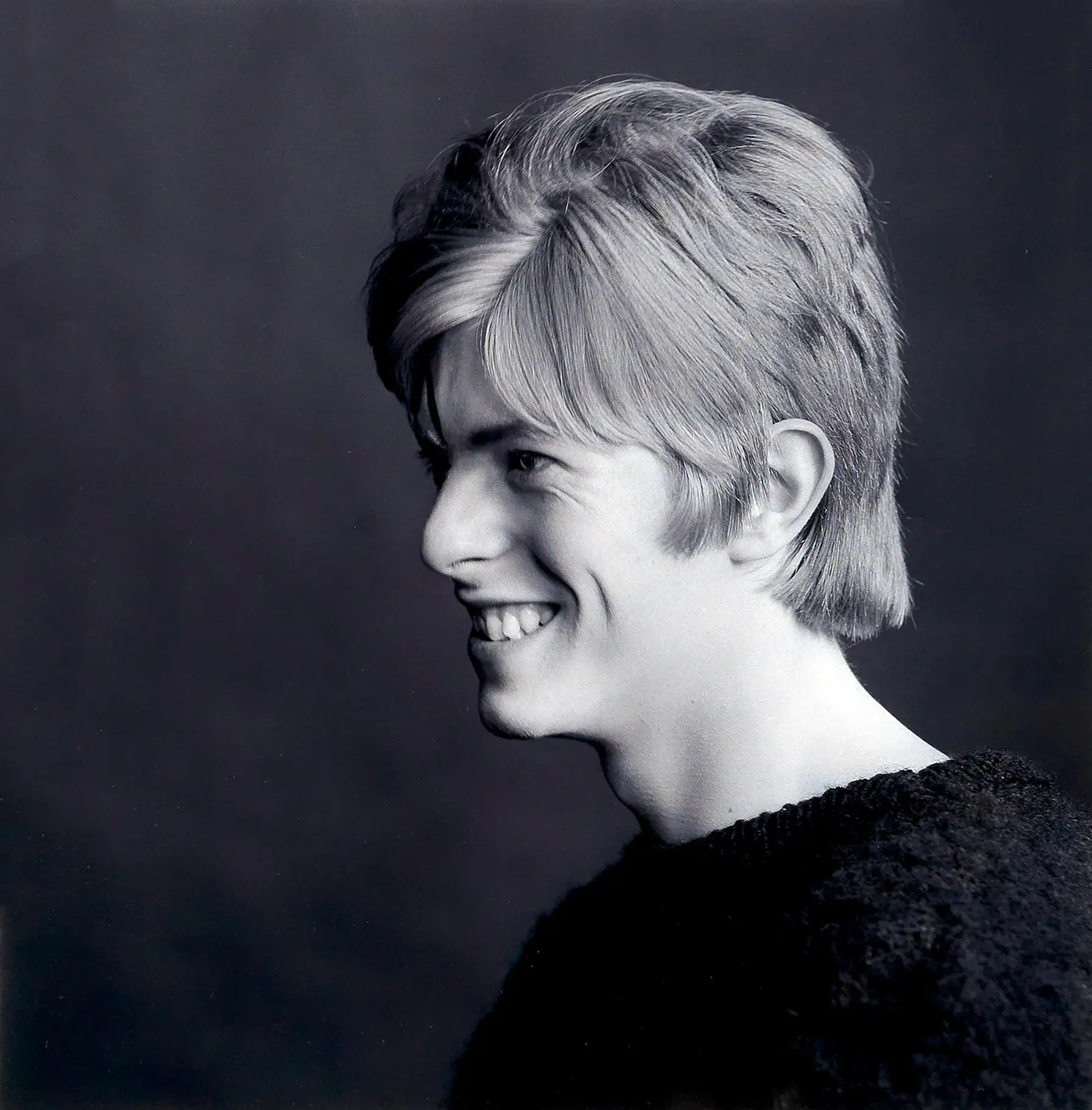 David Bowie Side Profile — candid black and white portrait featuring a young David Bowie in a side