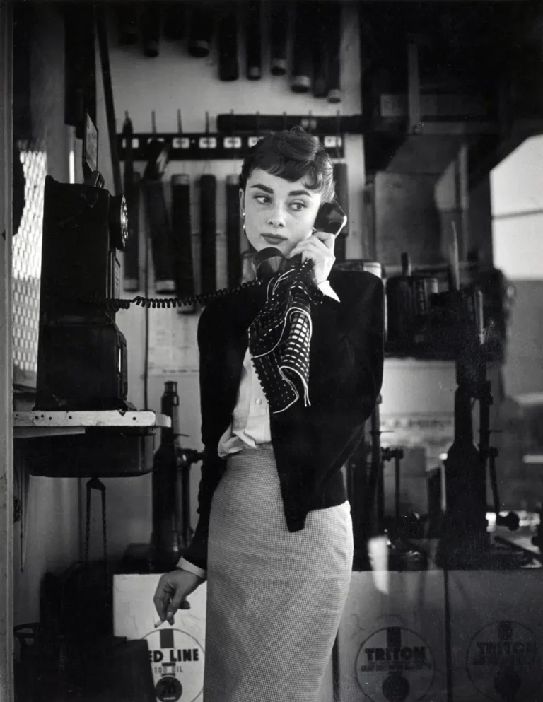 Audrey Hepburn Pay Phone Cigarette Photo print showing a vintage print of hepburn talking on a pay phone while holding a cig