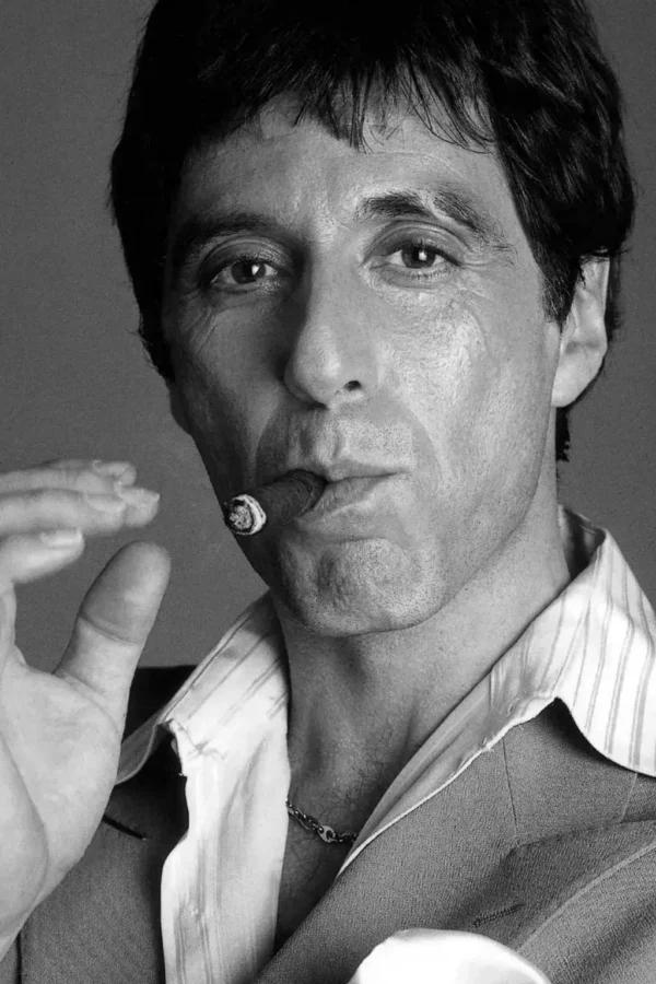 Black and white portrait of Al Pacino smoking a cigar with high-contrast lighting and a classic cinematic aesthetic.