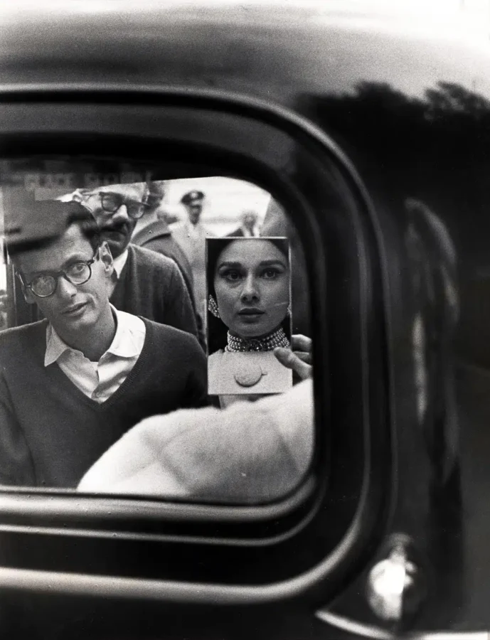 Black and white photography print of Audrey Hepburn reflected in a mirror with Richard Avedon looking through a car window.