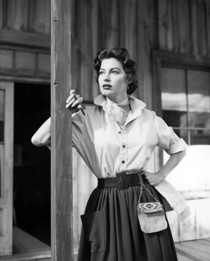 Ava Gardner in the 1952 film Lone Star leaning against a wooden post in a black and white photography print.