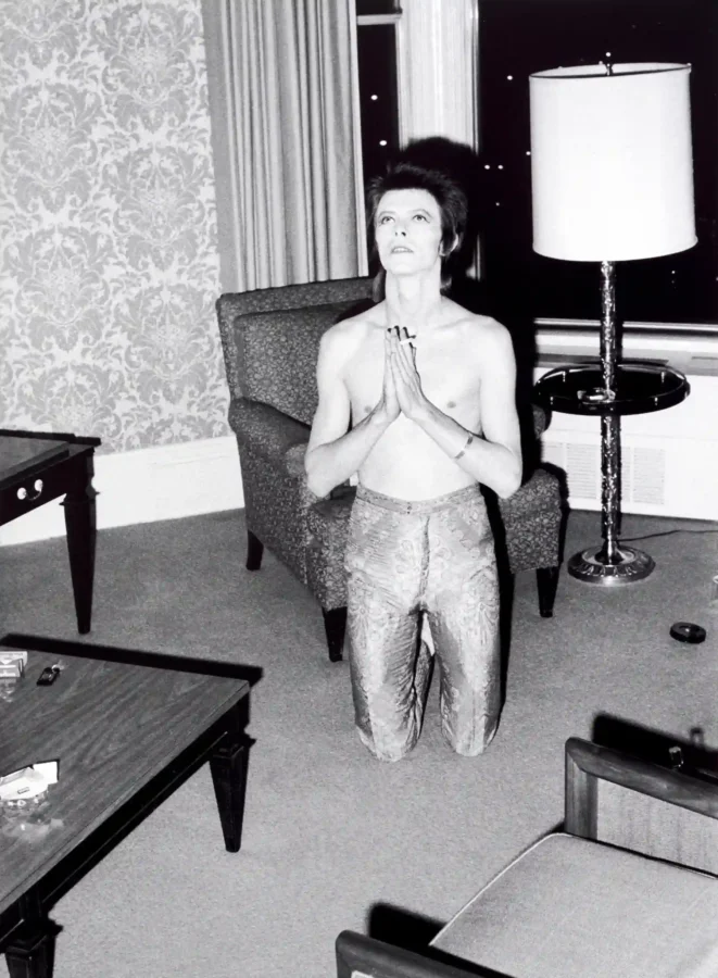 David Bowie Hotel Prayer — black and white photograph of David Bowie kneeling in a hotel room