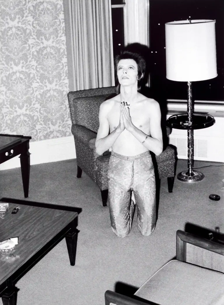 David Bowie Hotel Prayer — black and white photograph of David Bowie kneeling in a hotel room