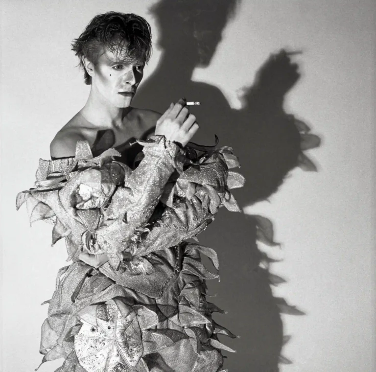 Clean artwork view of David Bowie Scary Monsters Pierrot Costume Black and White Photography Print. A high-contrast black and white photograph of David Bowie dressed as the Pierrot for the Scary Monsters era, featuring a dramatic long shadow and cigarette.