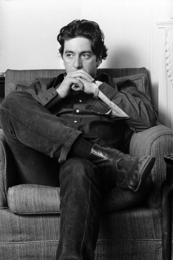 Black and white 1974 photography print of Al Pacino seated thoughtfully in an armchair with clasped hands and a watch.