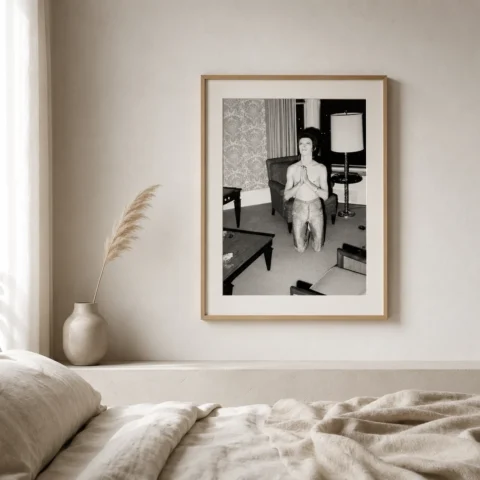 A framed black and white David Bowie hotel wall art print hanging in a modern living room setting.