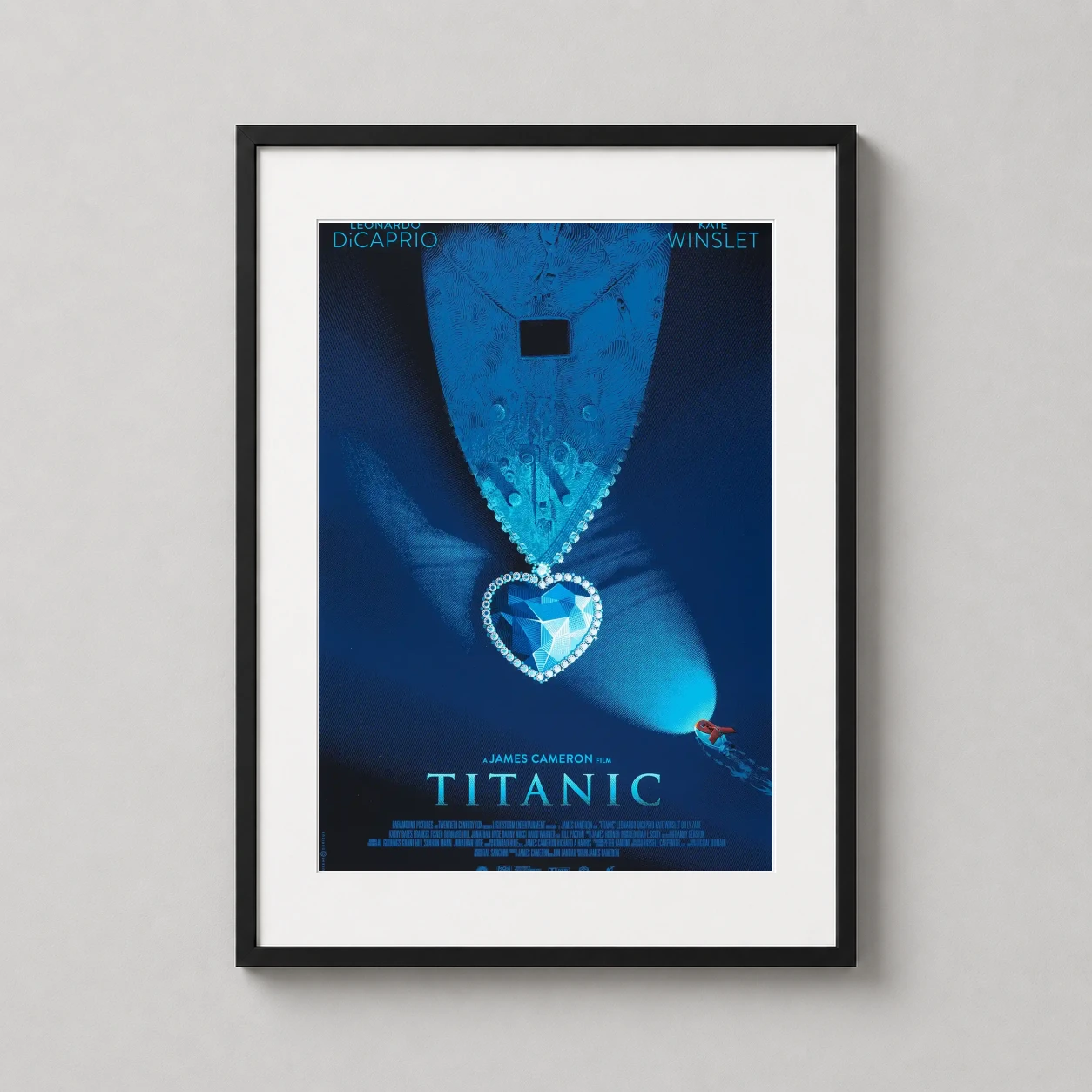 Room mockup of Titanic Laurent Durieux Heart of the Ocean Design Movie Poster, displayed as framed wall art in a home theater setting as a portrait print with black and white and blue tones.
