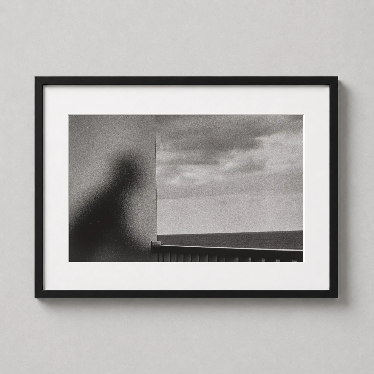 Room mockup of Martinique 1972 Andre Kertesz Abstract Silhouette Photography Print, displayed as framed wall art in a office setting as a landscape print with black and white tones.