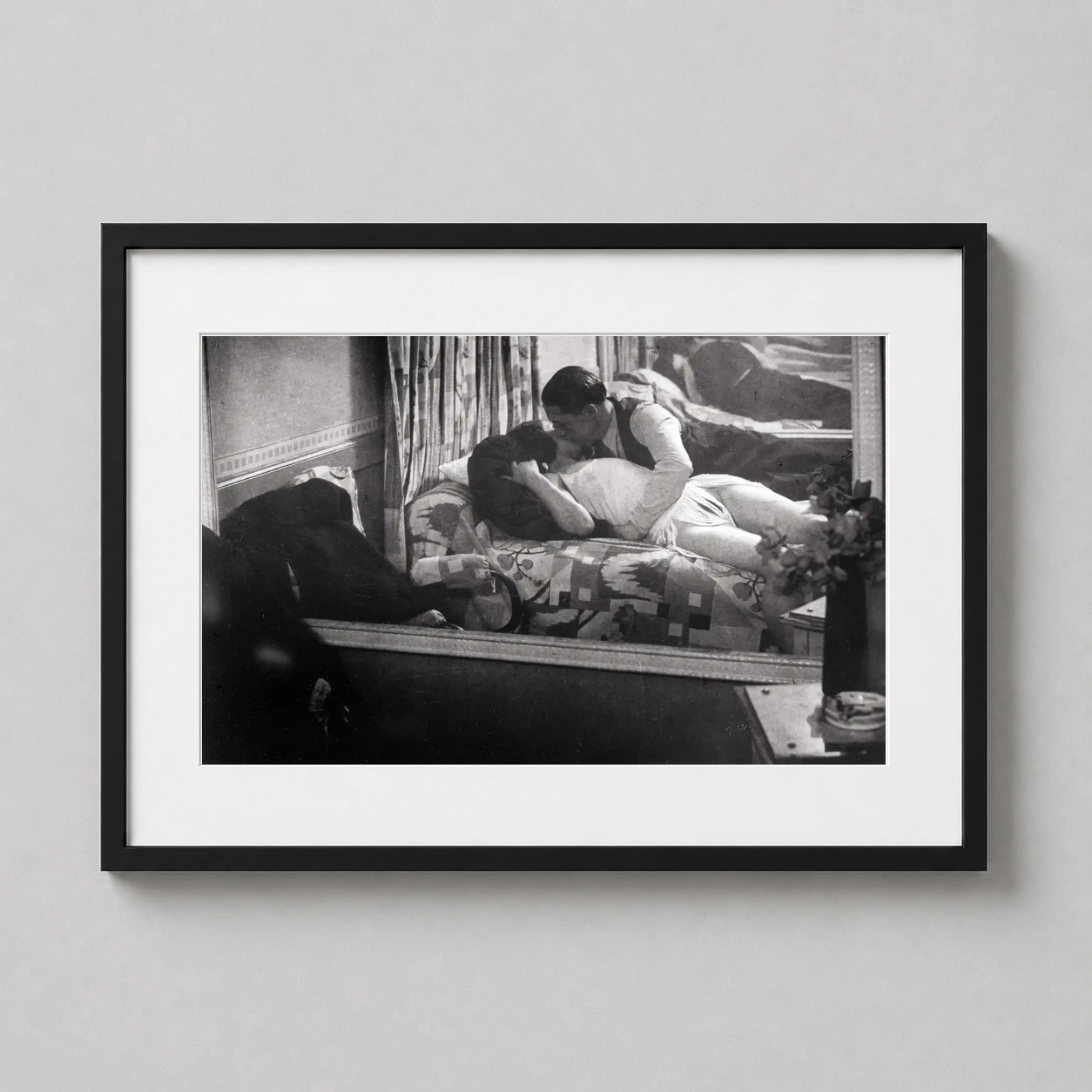 Room mockup of Brassaï Les Amants Chez Suzy 1932 Vintage Photography Print, displayed as framed wall art in a office setting as a landscape print with black and white tones.